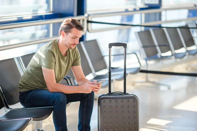 Passenger in a airport lounge waiting for a car.